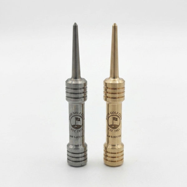 Stainless steel and brass barbell single prong divot tools standing upright