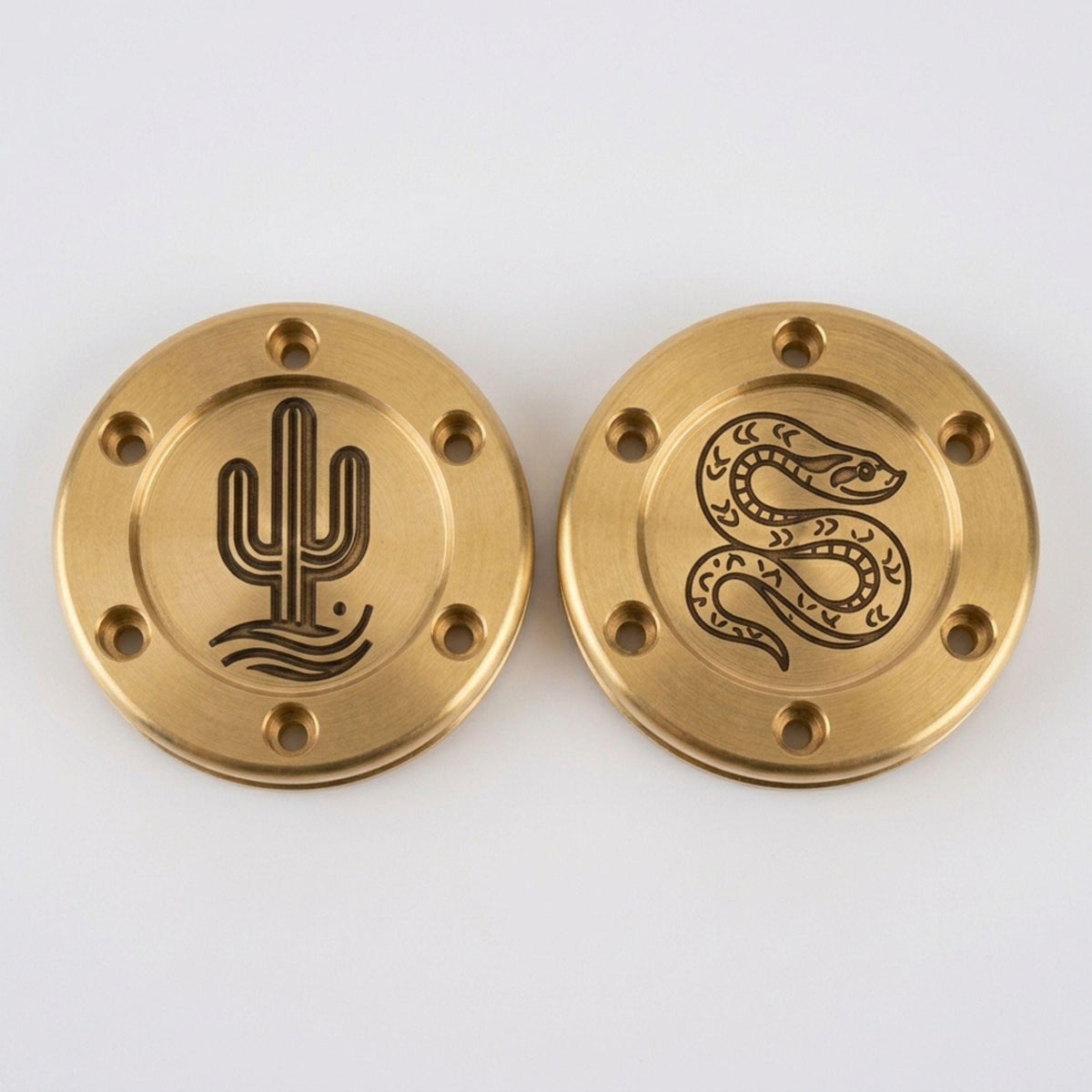 Pair of bronze putter weights engraved with a cactus and a coiled snake