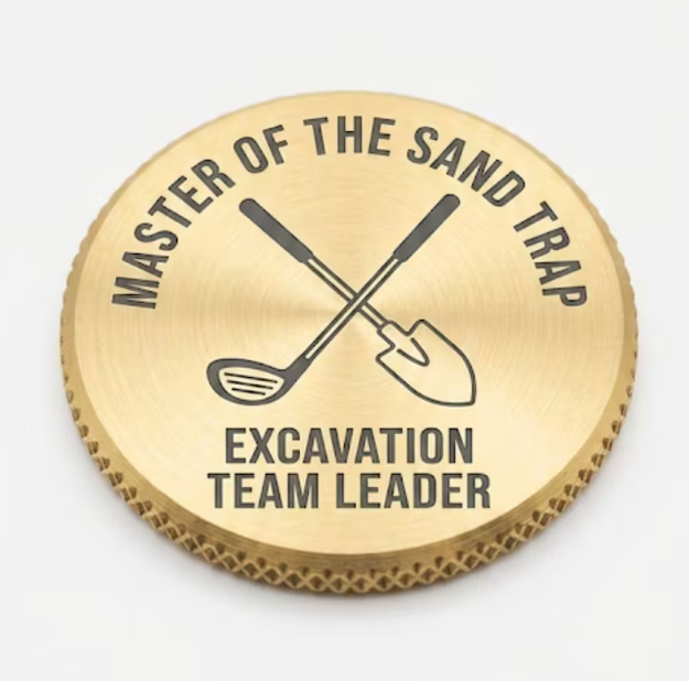 Brass golf ball marker engraved Master of the Sand Trap, Excavation Team Leader, with crossed club and shovel